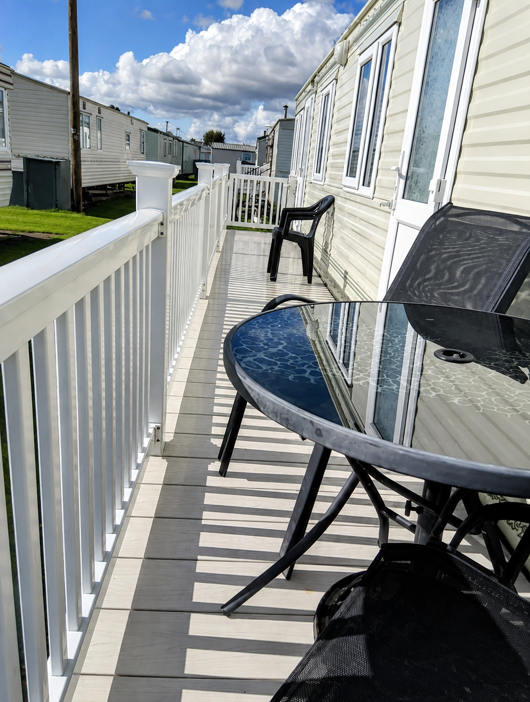 Outdoor table and chairs on the decking of caravan C40