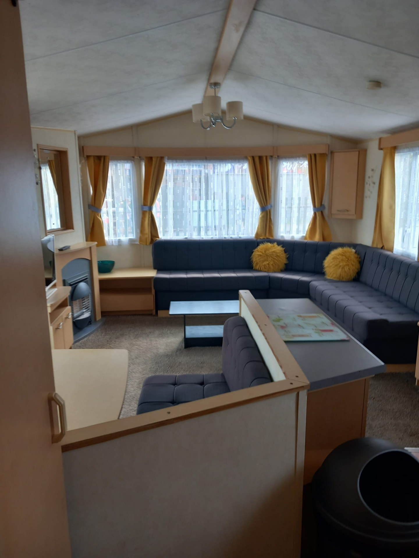 Lounge with grey corner sofa inside holiday caravan 370