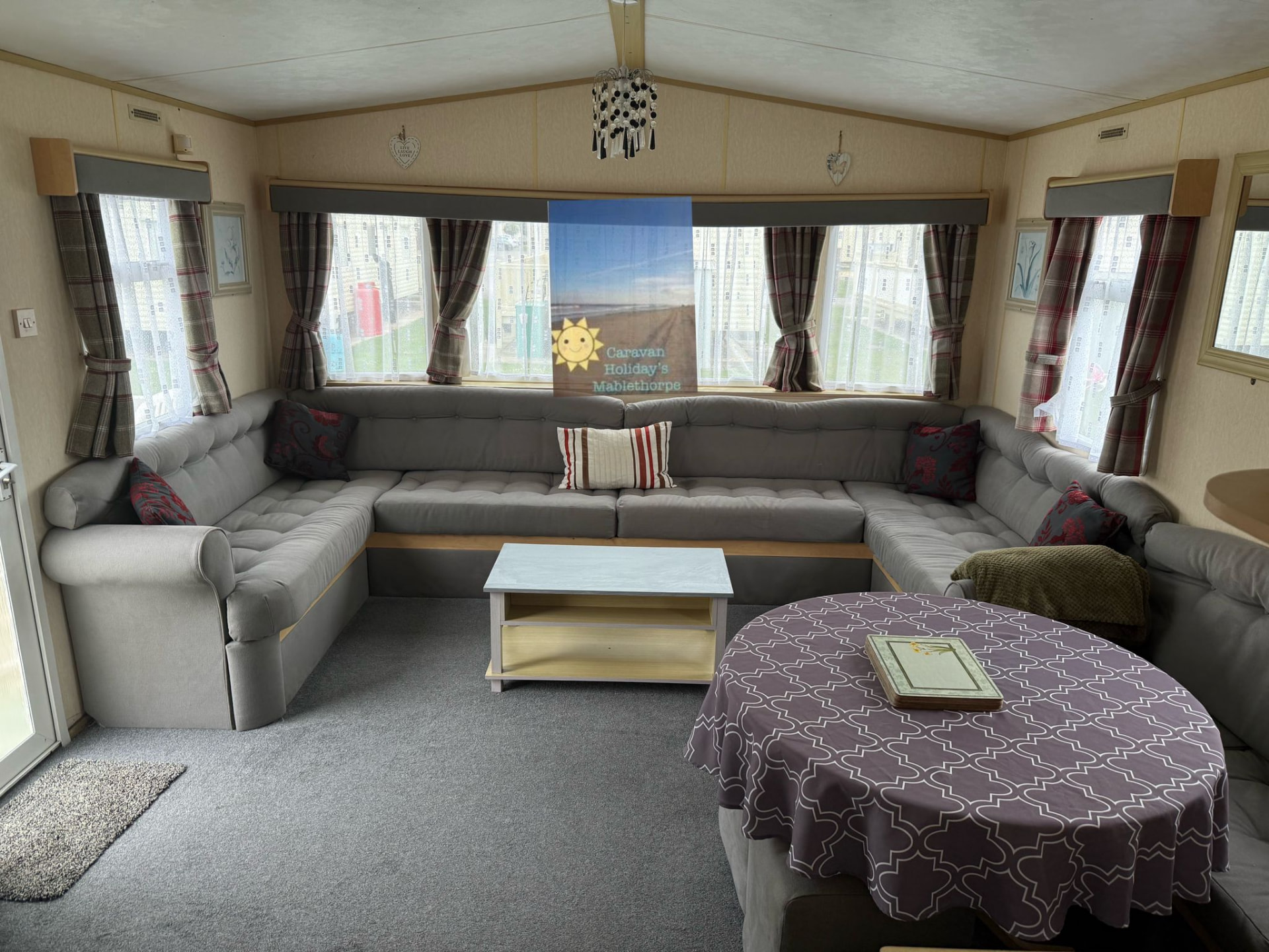 Large U-shaped lounge seating inside holiday caravan u2