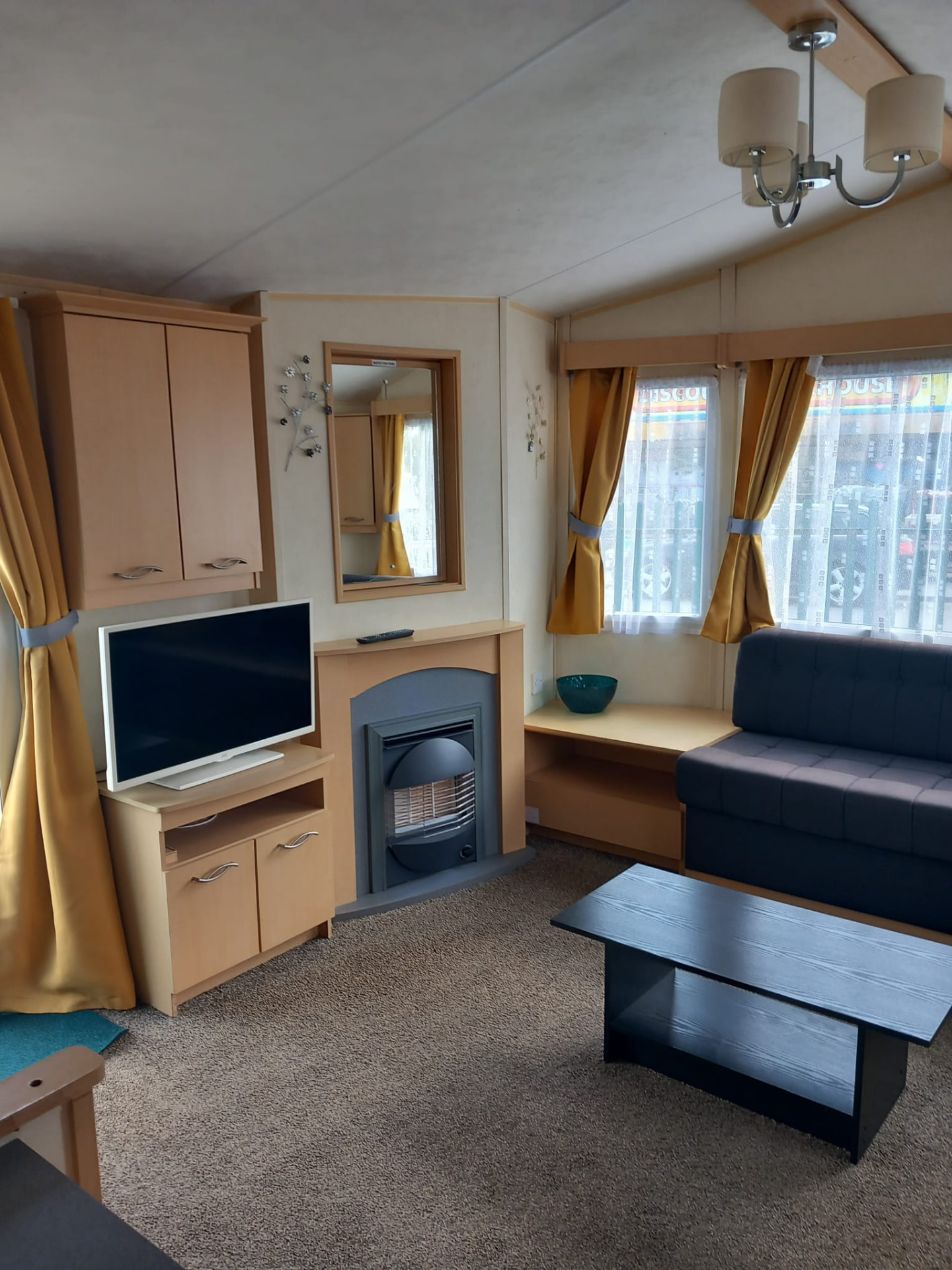 Television and fireplace in the lounge of caravan 370