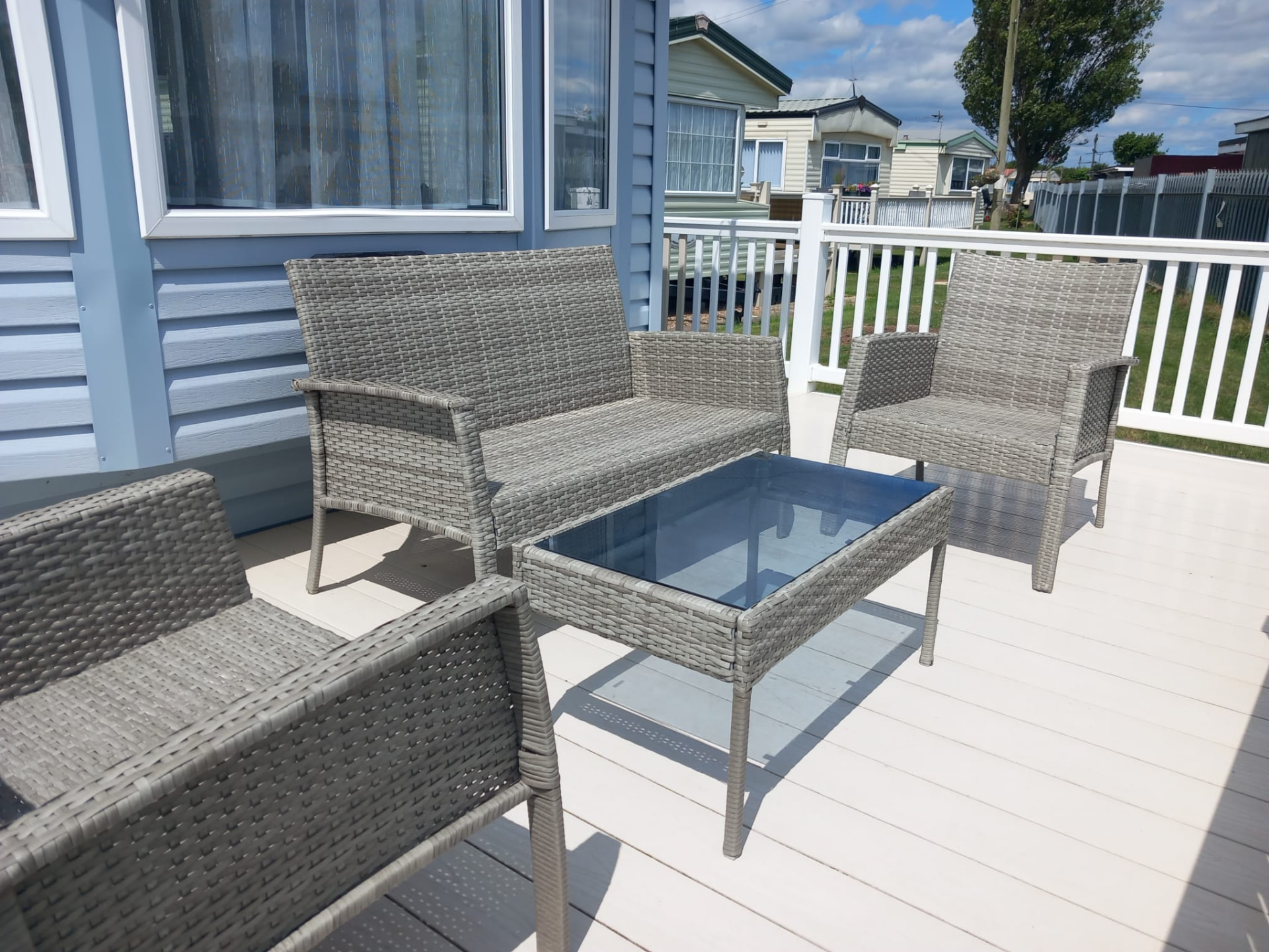 Outdoor wicker seating on the decking of caravan A13, Chapel St Leonards