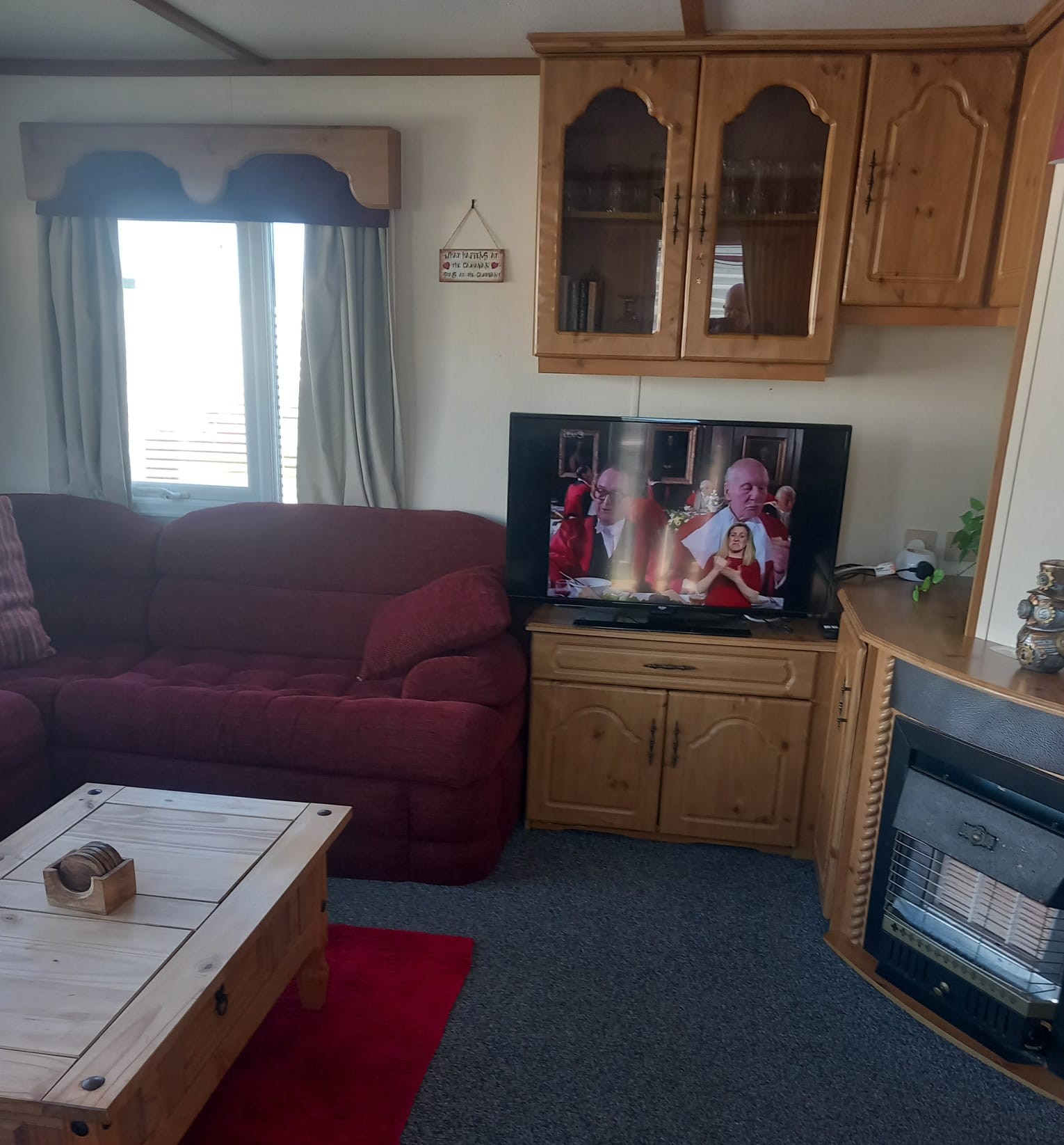 Lounge with corner sofa, television and fire inside caravan C40