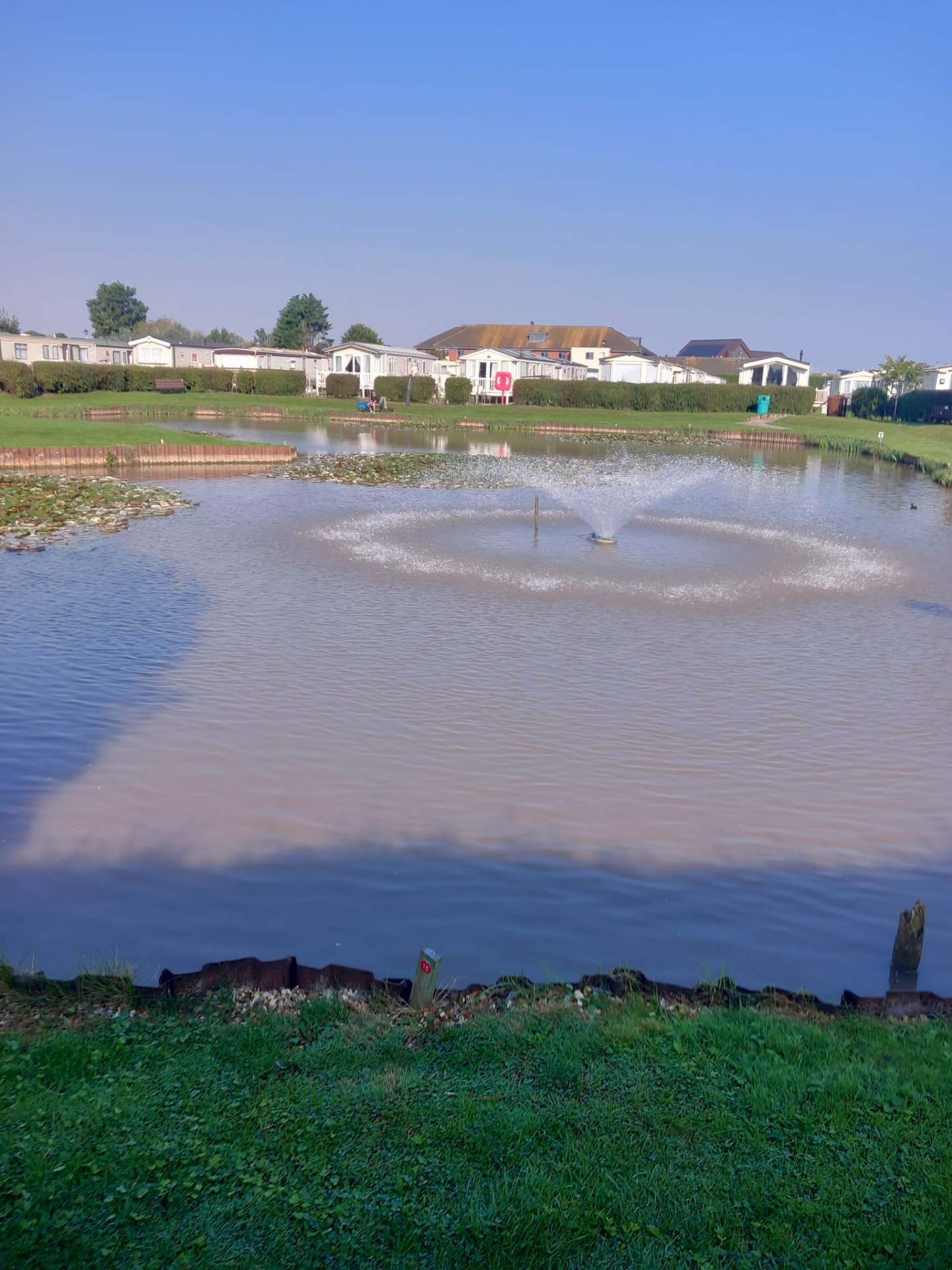 Fishing lake with fountain at Towervans Caravan Park, Mablethorpe