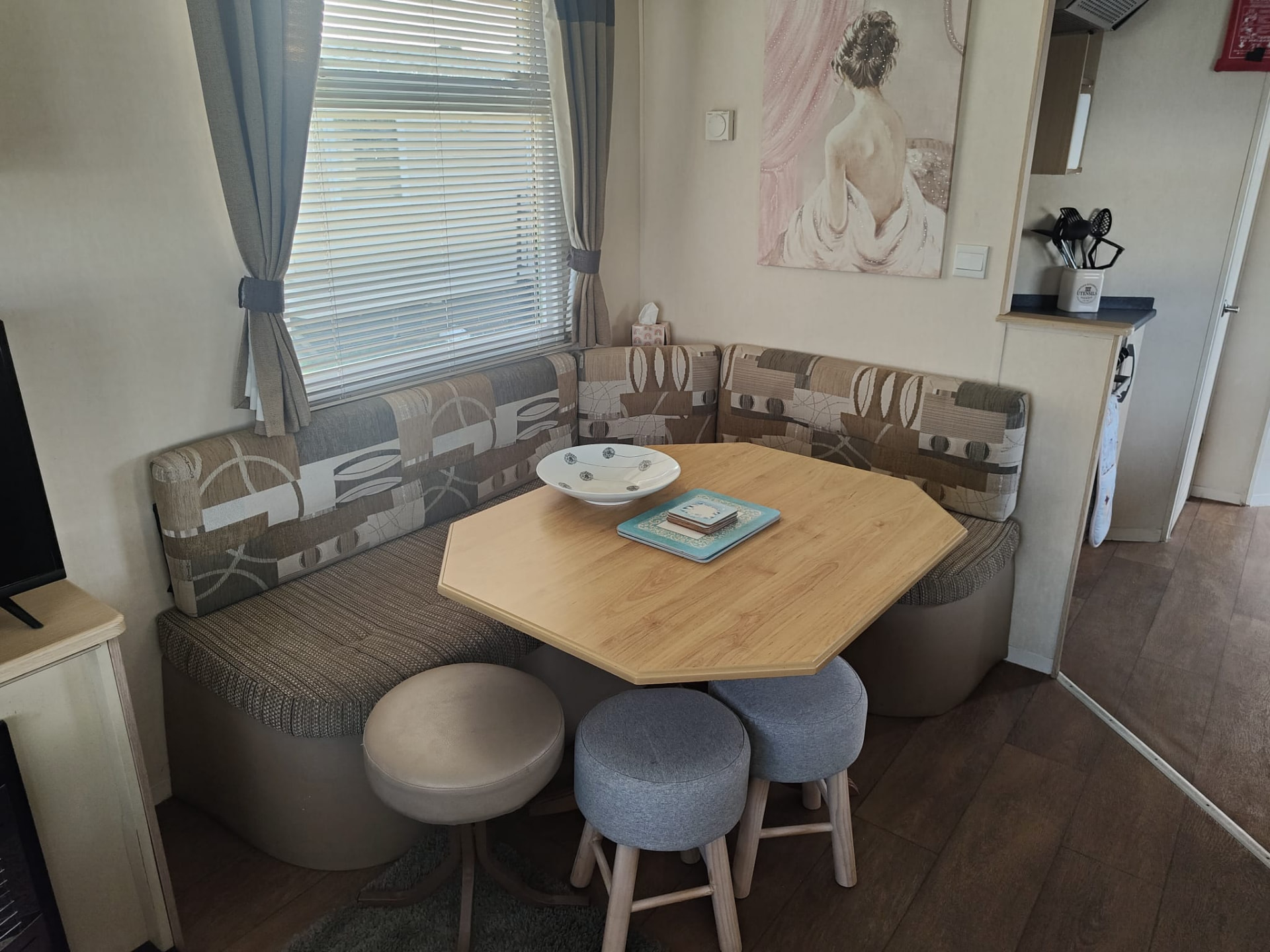 Dining area with table and stools inside caravan A13