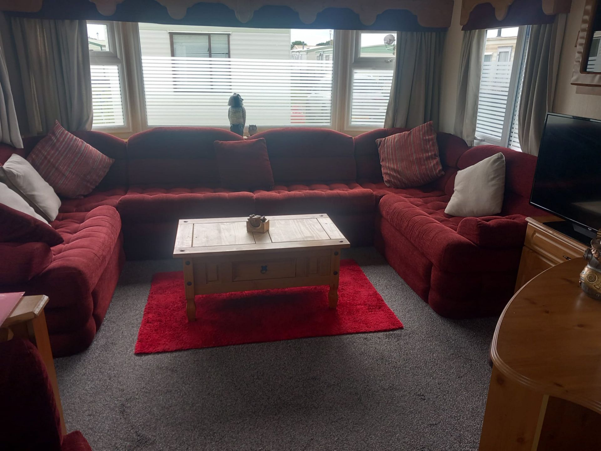 Corner sofa and coffee table inside holiday caravan C40